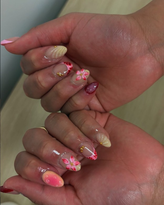 Almond nails with seashell, hibiscus and red French tips