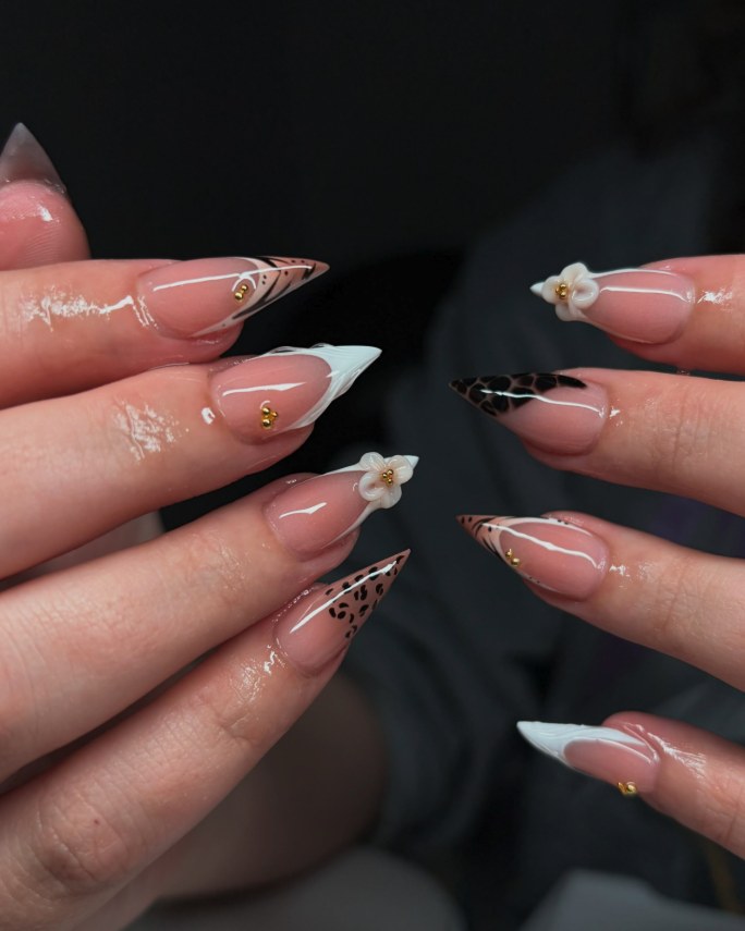 Long stiletto French tips with leopard print and 3D white flowers
