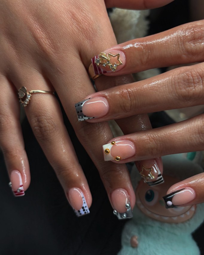Square French tips with polka dots, stripes and gold star charms